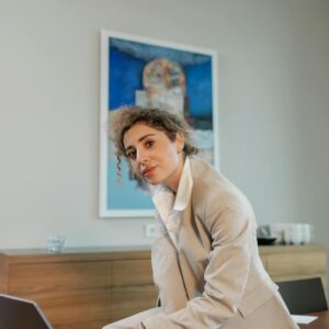 Woman in Beige Coat while using Laptop